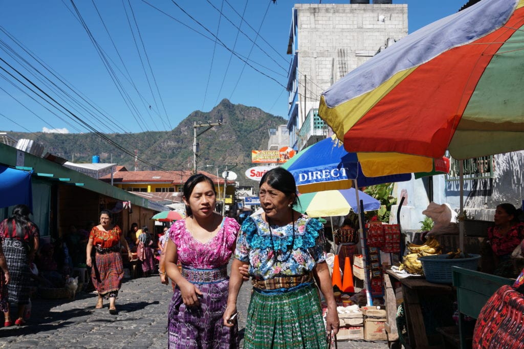 Mother and daughter in Mayan dress at local market San Pedro