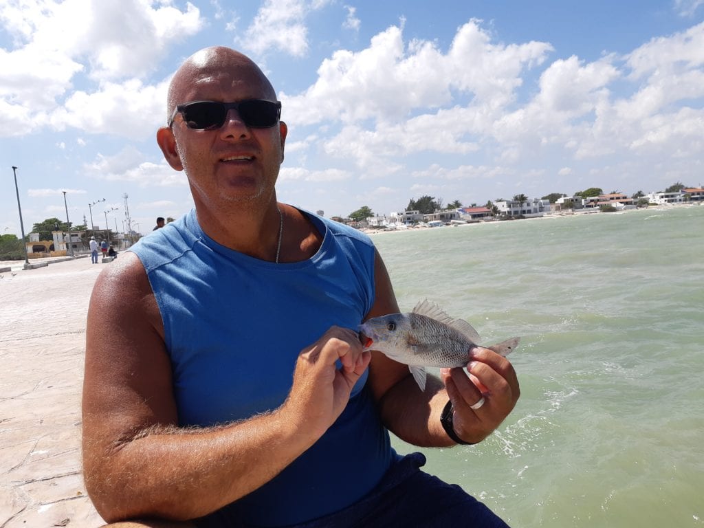 Person holding small fish