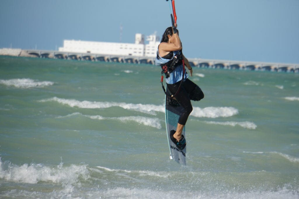 Girl kite surfing in air board vertical