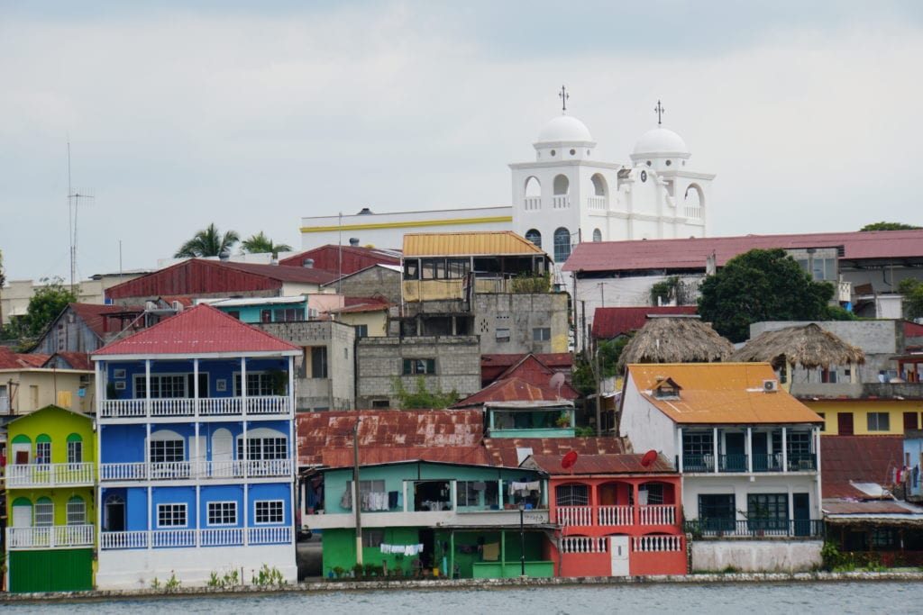 Colorful houses on lake shore with church in back ground Flores