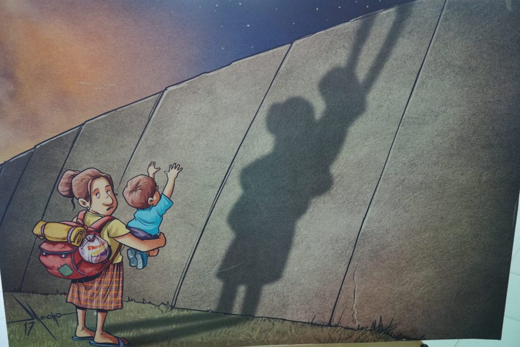 Refugee art, child reaching to climb a wall