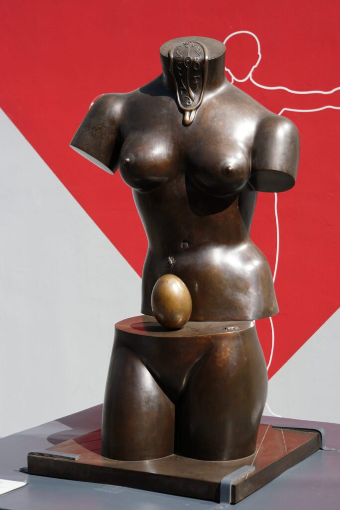 Bronze art women's top torso sitting on bottom showing egg