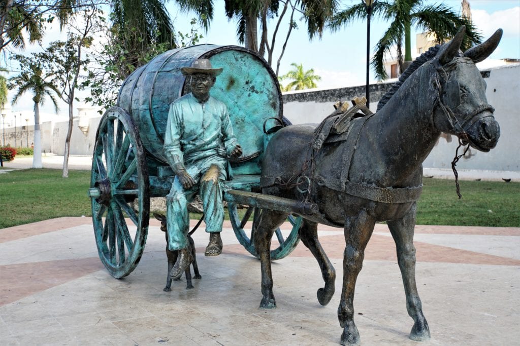 Bronze Monument donkey pulling barrel on cart with man the city Campeche