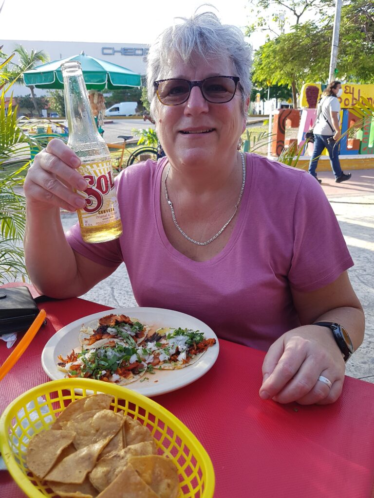 Cindy in Cancun enjoying lunch with a cerveza