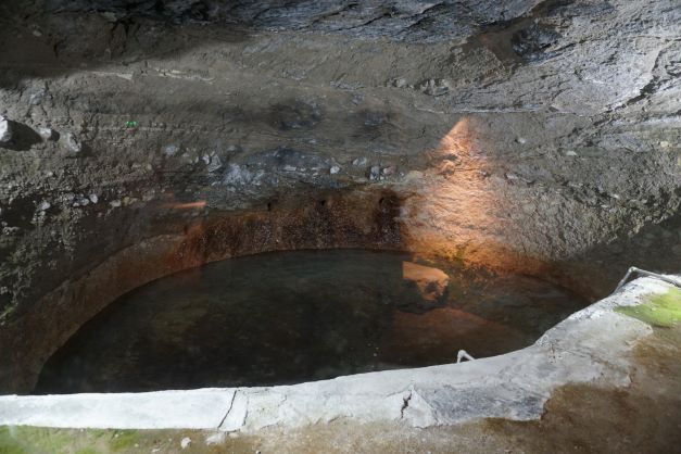 Pool of water from a spring that seeps from the caves walls said to be the tears of queen tama