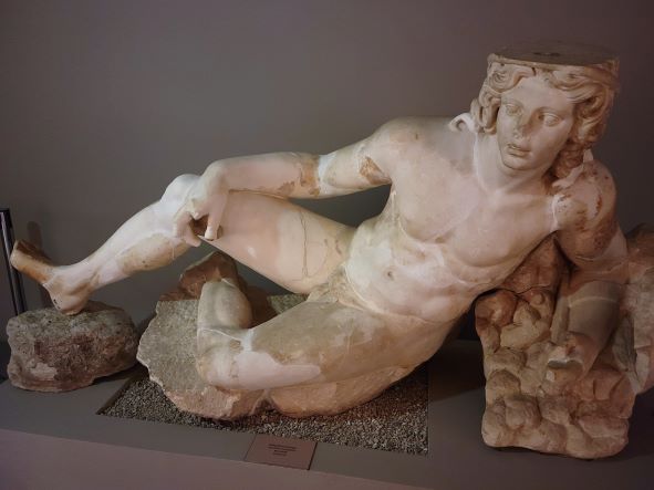 Man laying on his side at the Ephesus museum in Selcuk