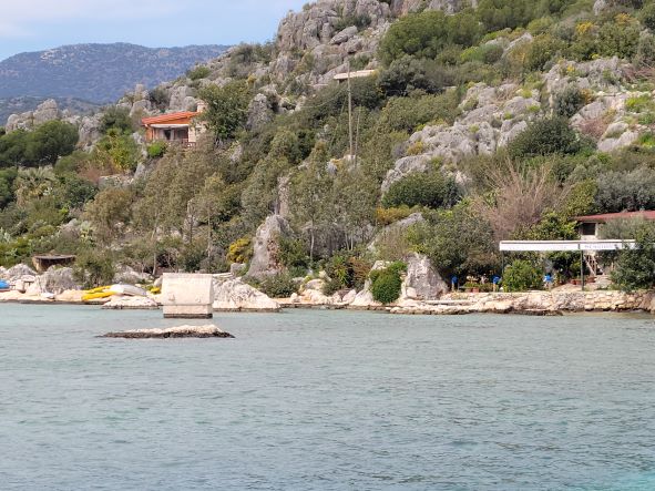 Lycian rock tomb sitting in the shallows of the bay