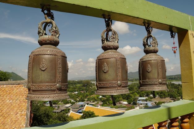 large gong bells hanging from supports at tiger temple